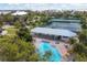 Aerial view of the community pool and tennis courts surrounded by lush tropical landscaping at 6890 Palm Island Dr, Placida, FL 33946