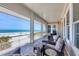 Enjoy ocean views from this screened in porch with seating areas at 6890 Palm Island Dr, Placida, FL 33946