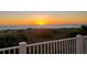 Gorgeous sunset view from the beach house balcony, with calming seas meeting the horizon, promoting tranquility at 6890 Palm Island Dr, Placida, FL 33946