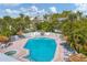 Inviting pool area with lounge chairs, shade umbrellas, and lush landscaping for ultimate relaxation at 6890 Palm Island Dr, Placida, FL 33946