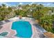 Inviting pool area with ample lounge seating and shade umbrellas perfect for relaxation and entertainment at 6890 Palm Island Dr, Placida, FL 33946