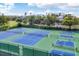 Enjoy a vibrant match at these well-maintained tennis courts, lined by tropical foliage and glimpses of neighborhood houses at 6890 Palm Island Dr, Placida, FL 33946