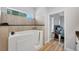 Bright bathroom featuring a walk-in soaking tub with jets and tile surround and access to a bedroom at 7332 Brandywine Dr, Englewood, FL 34224