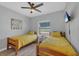 Bedroom with two twin beds, ceiling fan, and a window with a view of the outdoors and waterfront at 7332 Brandywine Dr, Englewood, FL 34224