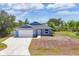 Charming single-Gathering home with an attached garage, lush landscaping, and a well-maintained lawn at 7332 Brandywine Dr, Englewood, FL 34224