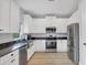 Well-lit kitchen with white cabinets, stainless steel appliances, and granite countertops at 7332 Brandywine Dr, Englewood, FL 34224