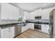 Modern kitchen featuring white cabinets, stainless steel appliances, and a window at 7332 Brandywine Dr, Englewood, FL 34224