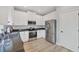 Kitchen with stainless steel appliances, granite counters, and white cabinets at 7332 Brandywine Dr, Englewood, FL 34224