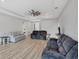 Bright living room featuring wood floors, recessed lighting, and multiple seating options at 7332 Brandywine Dr, Englewood, FL 34224