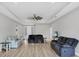 Open-concept living room featuring wood floors, recessed lighting and a ceiling fan at 7332 Brandywine Dr, Englewood, FL 34224