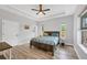 Bedroom with tray ceiling, ceiling fan, and bright windows at 7332 Brandywine Dr, Englewood, FL 34224
