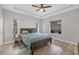 Spacious bedroom featuring wood flooring, a ceiling fan, and ample natural light at 7332 Brandywine Dr, Englewood, FL 34224
