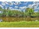 Lush tropical foliage surrounds the tranquil waterfront at 7332 Brandywine Dr, Englewood, FL 34224
