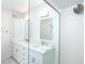 Modern bathroom features dual sinks, white cabinetry, and a walk-in shower with textured white tile at 7548 Palm Island S Dr # 1724, Placida, FL 33946