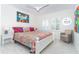 Bedroom with colorful decor, white furnishings, wood tile floors, and a Gulf view window at 7548 Palm Island S Dr # 1724, Placida, FL 33946