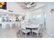 Bright dining area with modern light fixture with view into the updated kitchen at 7548 Palm Island S Dr # 1724, Placida, FL 33946