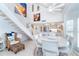 Open-concept dining area with a staircase, modern lighting, and a view into the kitchen at 7548 Palm Island S Dr # 1724, Placida, FL 33946
