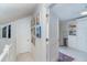 Hallway features a wall of art leading to another room with an open door at 7548 Palm Island S Dr # 1724, Placida, FL 33946