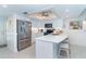 Modern kitchen featuring white cabinets, stainless steel appliances, and a center island with seating at 7548 Palm Island S Dr # 1724, Placida, FL 33946