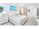 Bright main bedroom features white furniture, coastal art, and shuttered windows with Gulf views at 7548 Palm Island S Dr # 1724, Placida, FL 33946