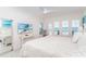 Bright main bedroom with white furniture, a TV, and Gulf views from shuttered windows at 7548 Palm Island S Dr # 1724, Placida, FL 33946