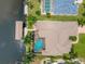 Aerial view of a waterfront home with a pool and private boat dock at 8180 Burwell Cir, Port Charlotte, FL 33981