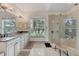 Bright primary bathroom with dual sinks, a glass shower, and a large window at 8180 Burwell Cir, Port Charlotte, FL 33981