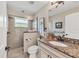 Elegant bathroom features a glass shower, marble countertop vanity, and attractive fixtures at 8180 Burwell Cir, Port Charlotte, FL 33981