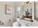 Charming powder room features flamingo art, marble countertop, toilet, and attractive fixtures at 8180 Burwell Cir, Port Charlotte, FL 33981