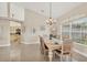 Bright dining room featuring tile floors, neutral décor, and a seamless flow to the kitchen at 8180 Burwell Cir, Port Charlotte, FL 33981