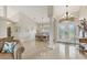 Bright foyer with high ceilings, tile floors, and double doors that lead to a formal dining space at 8180 Burwell Cir, Port Charlotte, FL 33981