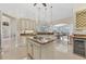 Bright kitchen with island cooktop, granite counters, wine cooler, and open floor plan at 8180 Burwell Cir, Port Charlotte, FL 33981