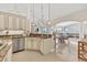 Updated kitchen featuring granite counters, stainless steel appliances, and tiled floors at 8180 Burwell Cir, Port Charlotte, FL 33981