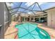 Stunning screened pool and spa area with ample seating, outdoor TV, and waterfront views at 8180 Burwell Cir, Port Charlotte, FL 33981