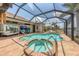 Relax and unwind in this screened-in pool and spa area with a water view at 8180 Burwell Cir, Port Charlotte, FL 33981