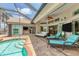 Beautiful pool and spa in a screened enclosure with multiple lounge areas for ultimate relaxation at 8180 Burwell Cir, Port Charlotte, FL 33981