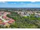 An aerial view showcases a residential community with lush greenery and scenic waterways throughout at 8320 Creekview Ln, Englewood, FL 34224