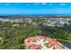 An aerial view displays a beautiful community near the coast, surrounded by lush trees and water features at 8320 Creekview Ln, Englewood, FL 34224