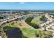Breathtaking aerial view of a community with a golf course, lakes, and well-maintained residences at 8320 Creekview Ln, Englewood, FL 34224