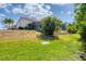 Beautiful property with a spacious backyard that features a covered lanai and lush landscaping at 8320 Creekview Ln, Englewood, FL 34224
