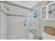 Clean bathroom with glass-enclosed shower and built-in storage at 8320 Creekview Ln, Englewood, FL 34224