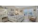 Cozy bedroom features coastal decor, bright light, and calming atmosphere at 8320 Creekview Ln, Englewood, FL 34224