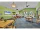 Bright and airy community room with comfortable seating, a TV, and access to outdoor amenities at 8320 Creekview Ln, Englewood, FL 34224