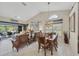 Dining room featuring wood table and chairs, view to the outdoor patio and natural light at 8320 Creekview Ln, Englewood, FL 34224