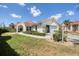 Well-maintained home featuring lush green lawn and manicured hedges along a tiled roof in a sunny neighborhood at 8320 Creekview Ln, Englewood, FL 34224