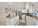 Bright kitchen with center island, stainless steel appliances, and checkered backsplash at 8320 Creekview Ln, Englewood, FL 34224