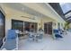 Inviting covered lanai with a ceiling fan, dining set and seamless access to indoor living areas at 8320 Creekview Ln, Englewood, FL 34224