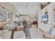 Spacious living room with nautical décor, vaulted ceilings, and comfortable seating at 8320 Creekview Ln, Englewood, FL 34224