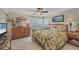 Tropical style main bedroom, hardwood floors, and beachy decor at 8320 Creekview Ln, Englewood, FL 34224