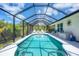 Enjoy the outdoors in this screened pool area with lounge chairs and access to the covered patio area at 8320 Creekview Ln, Englewood, FL 34224